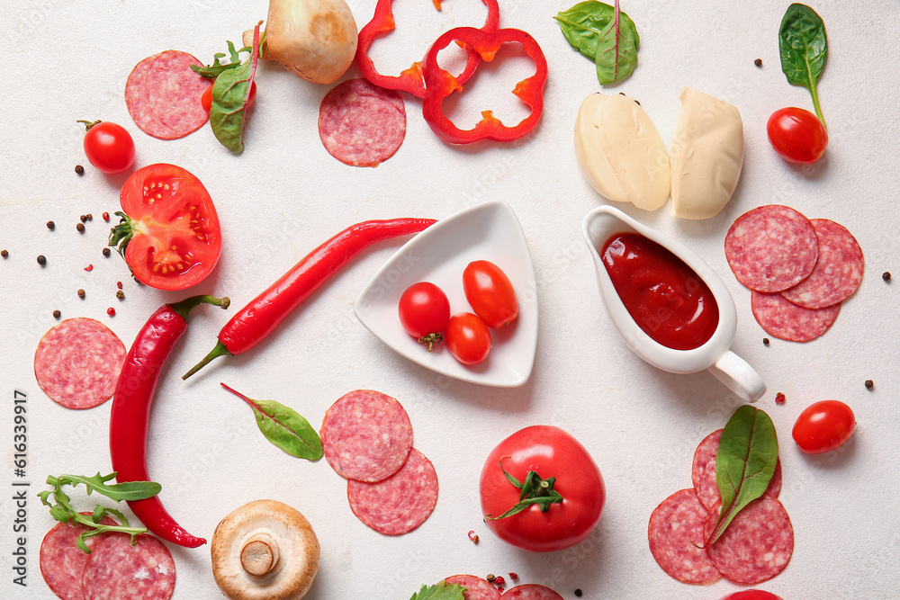 Different ingredients for preparing pizza on light background