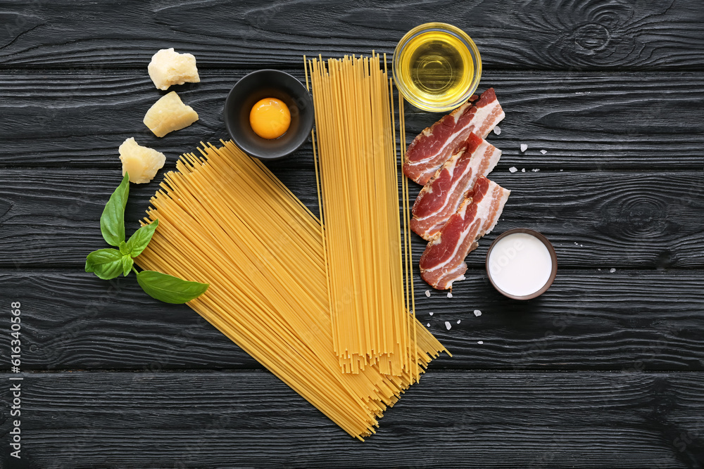 Ingredients for delicious pasta carbonara on dark wooden background