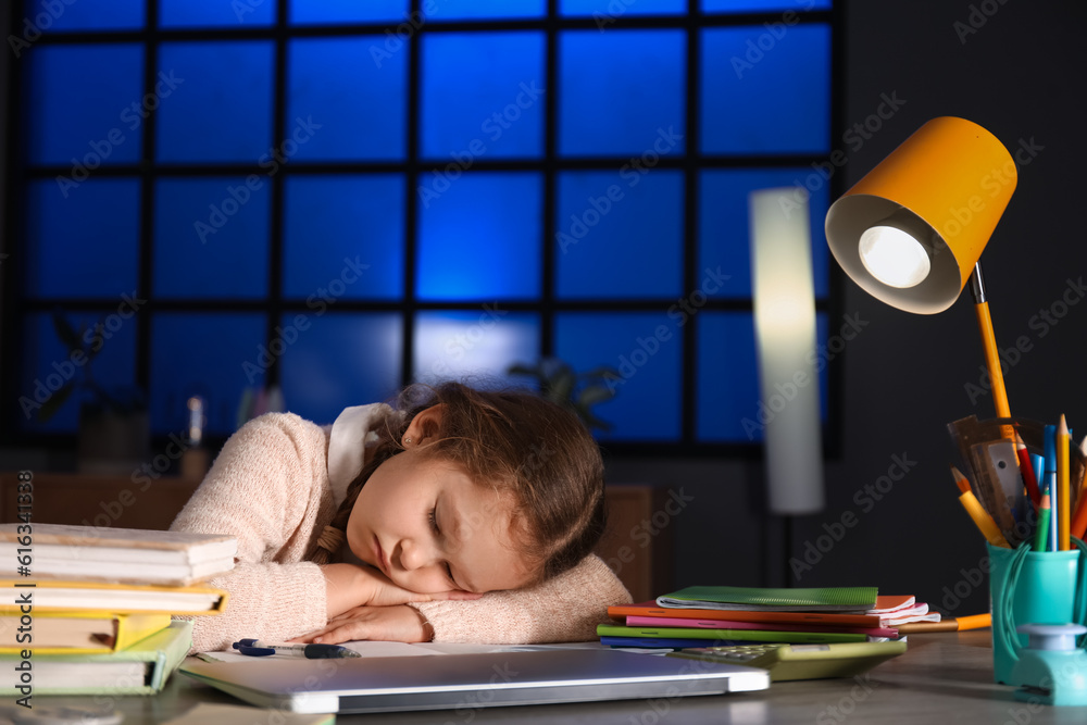 Little girl sleeping at table late in evening