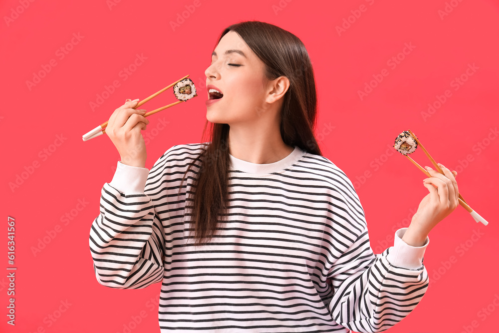 Young woman with sushi on red background