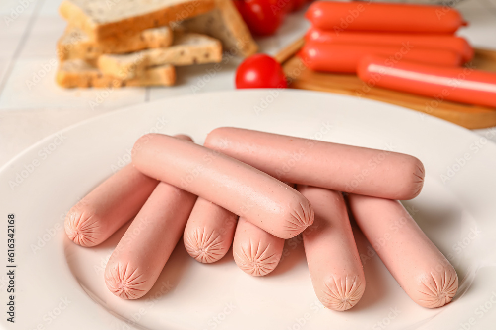 Plate with tasty thin sausages and tomatoes, closeup