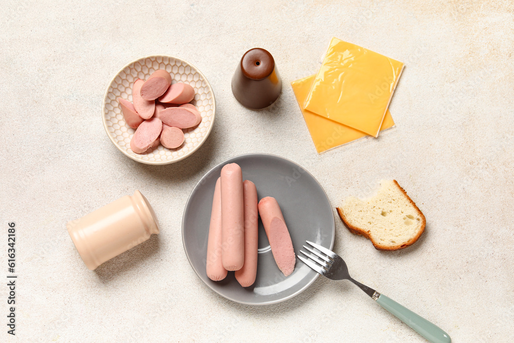 Bowl and plate with tasty thin sausages on white background