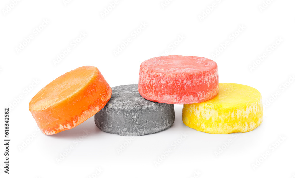 Colorful solid shampoo bars on white background