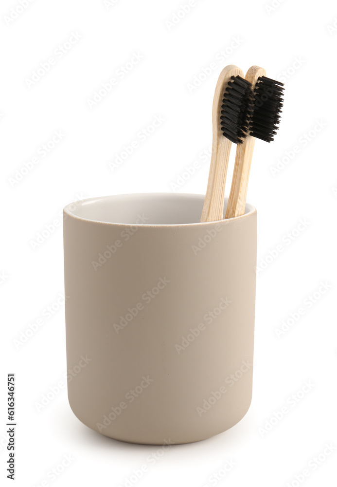 Bamboo tooth brushes in holder on white background