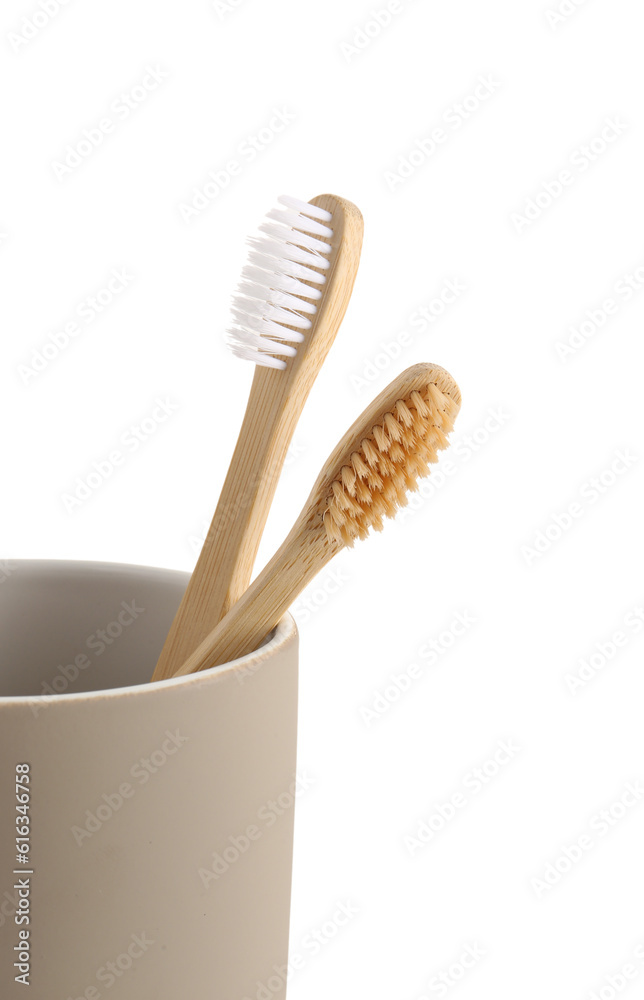 Bamboo tooth brushes in holder on white background, closeup