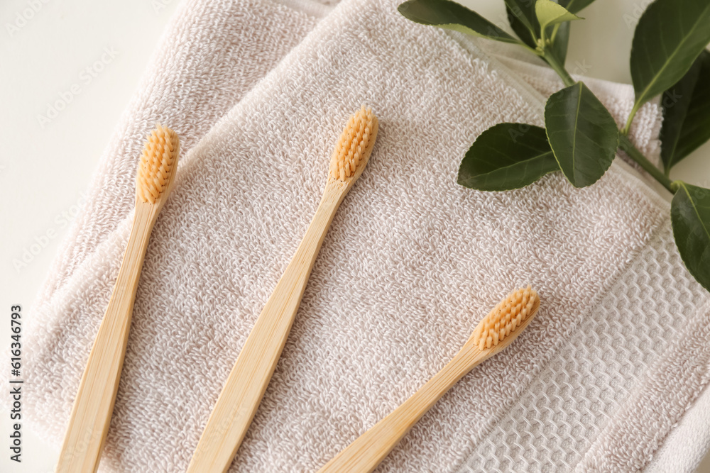 Bamboo tooth brushes on towel, top view