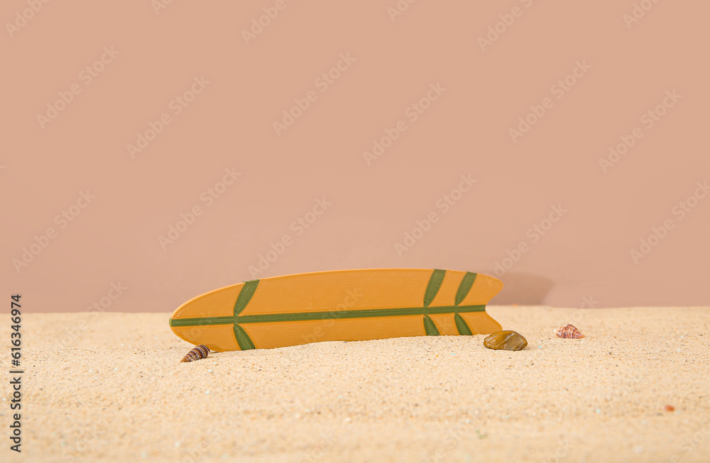 Mini surfboard with seashells on sand against brown background