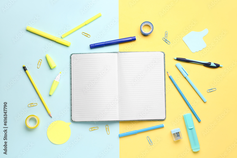 Notebook with different stationery on color background