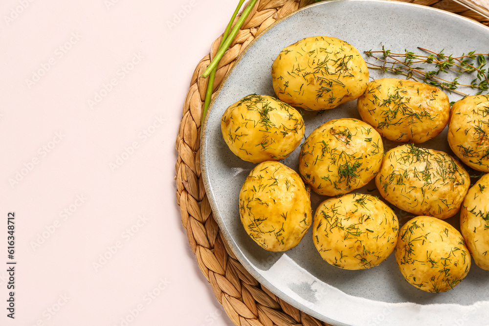 Plate of boiled baby potatoes with dill on white background