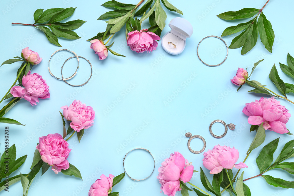 Frame made of stylish female accessories and beautiful peony flowers on color background