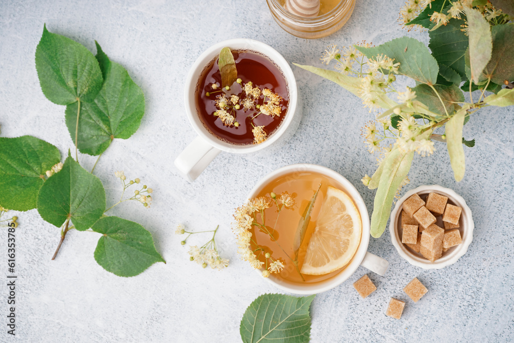 Cups of linden tea with lemon on white background