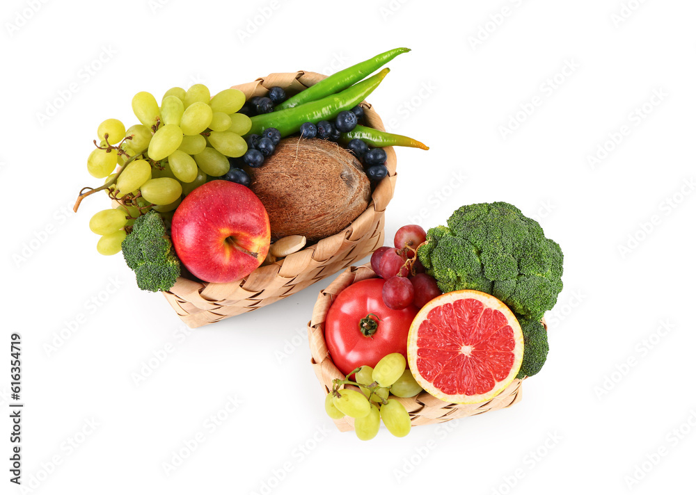 Wicker baskets with different fresh fruits and vegetables on white background