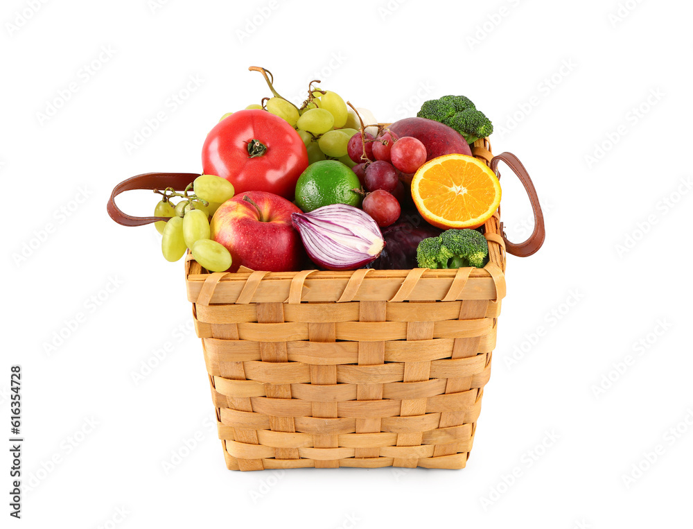 Wicker basket with different fresh fruits and vegetables on white background