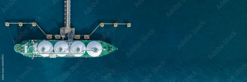 LNG (Liquified Natural Gas) tanker anchored in Gas terminal gas tanks for storage. Oil Crude Gas Tan