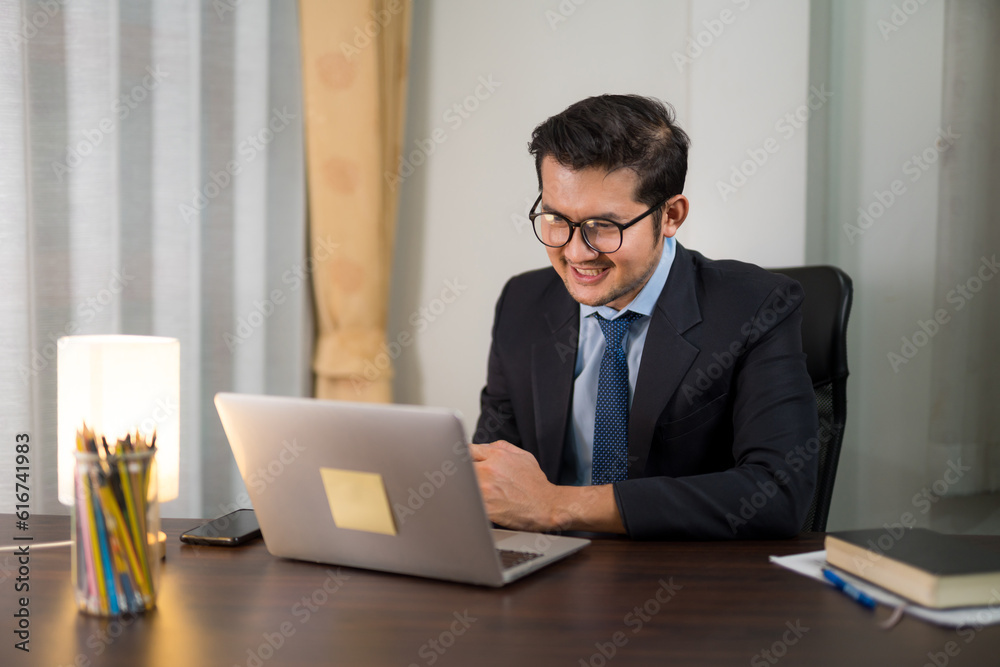 Asian businessman having online meeting with laptop from home.