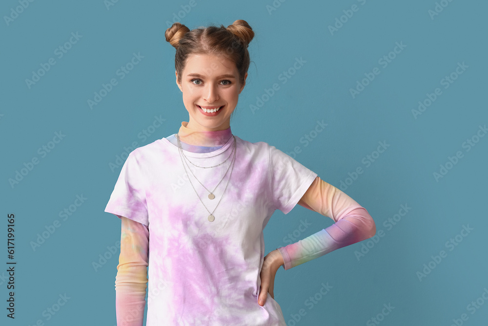 Young woman in tie-dye t-shirt on blue background