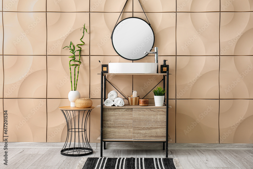 Interior of bathroom with sink, shelving unit and mirror