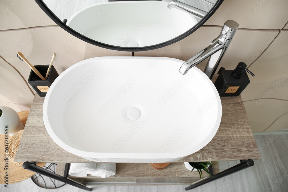 White sink with soap on shelf in bathroom