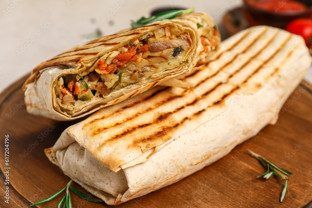 Board with tasty shawarma and rosemary, closeup