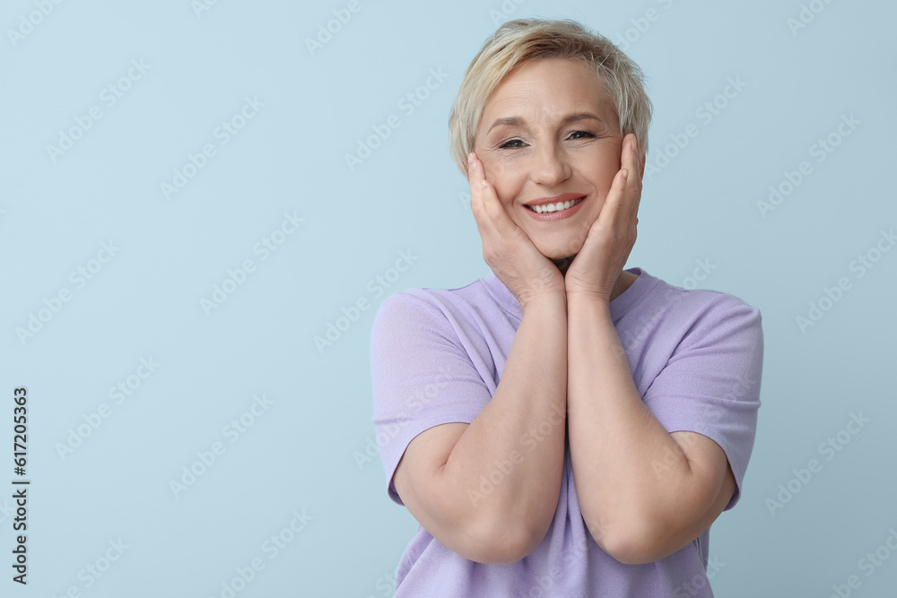 Mature blonde woman on light background