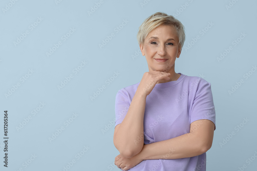 Mature blonde woman on light background