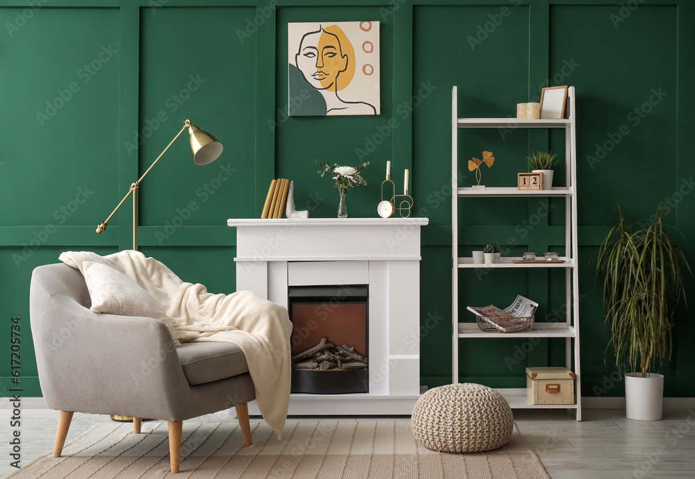 Interior of living room with armchair, fireplace and shelving unit