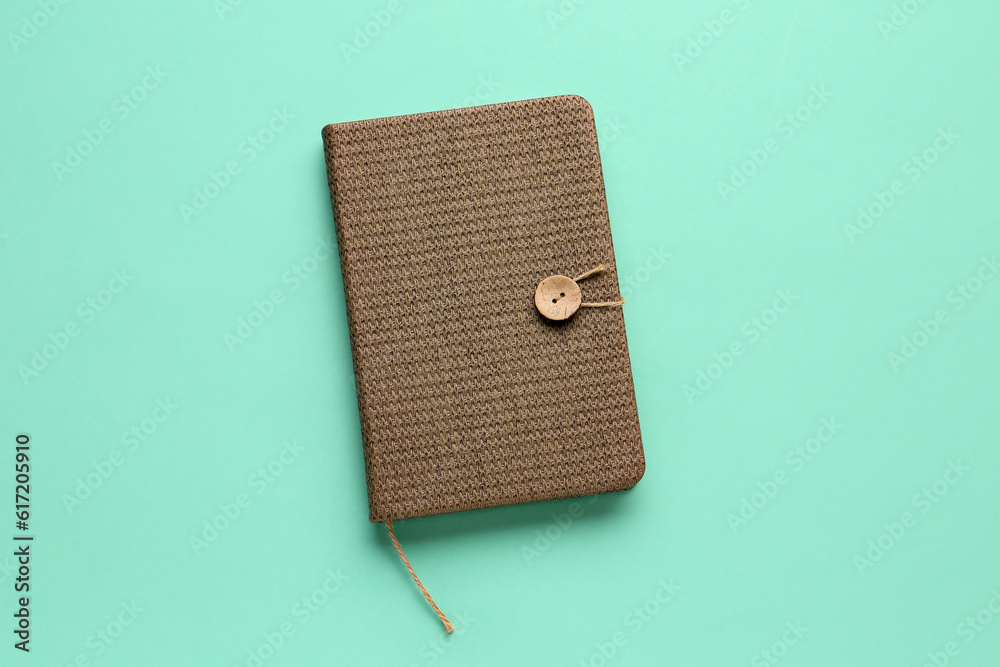 Stylish notebook on color background