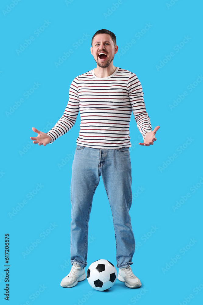 Screaming man with soccer ball on blue background