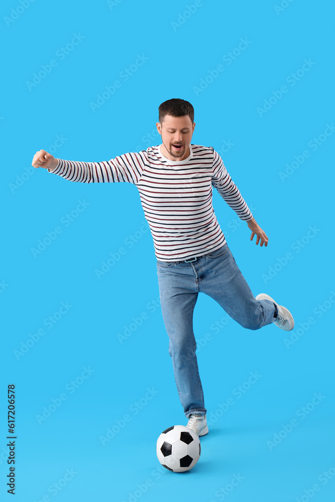 Man playing with soccer ball on blue background