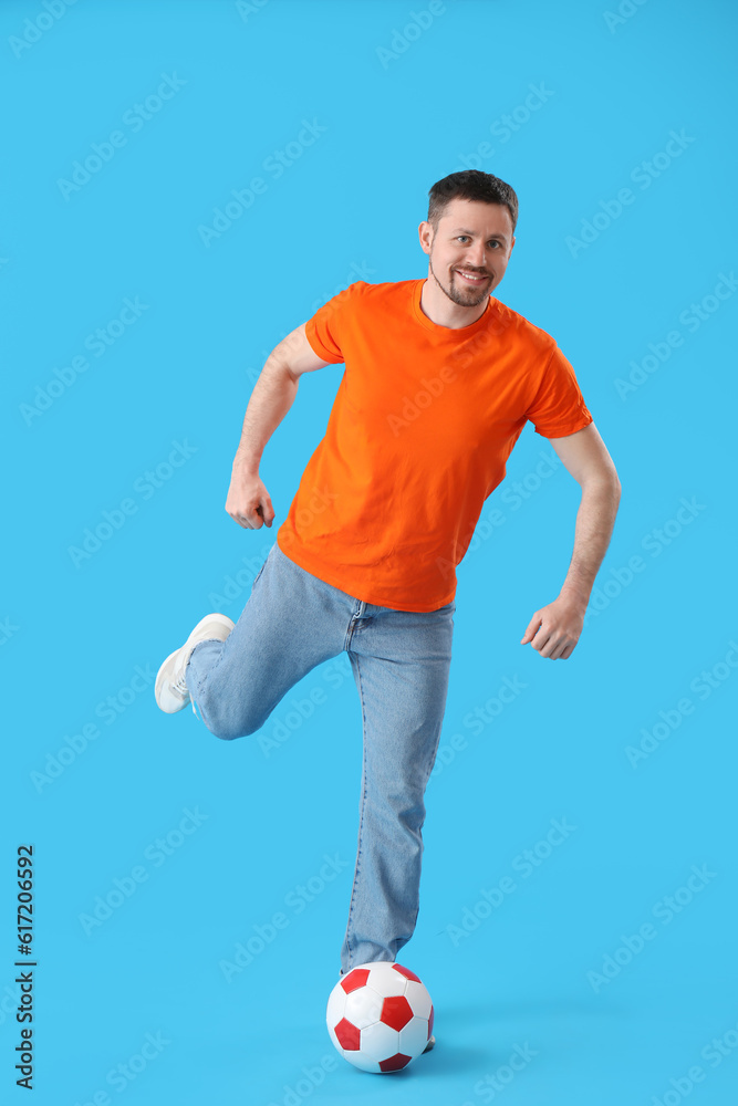 Man playing with soccer ball on blue background