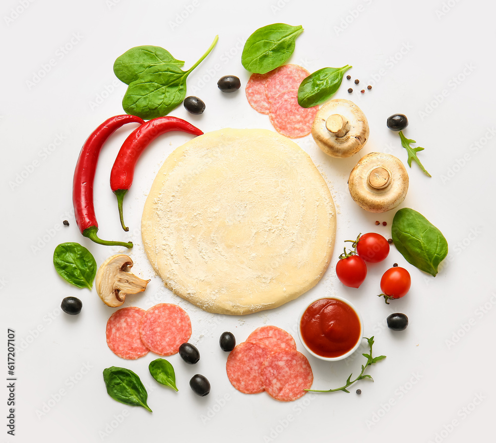 Raw dough and ingredients for preparing pizza on white background