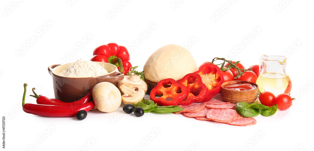 Raw dough and ingredients for preparing pizza on white background