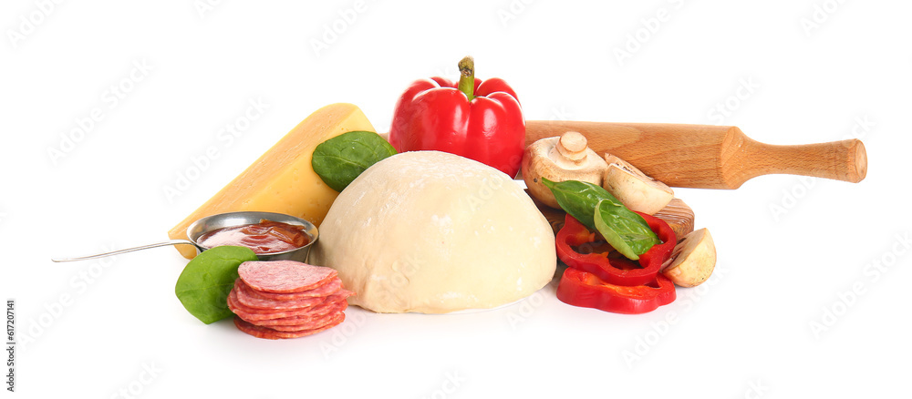 Raw dough and ingredients for preparing pizza on white background