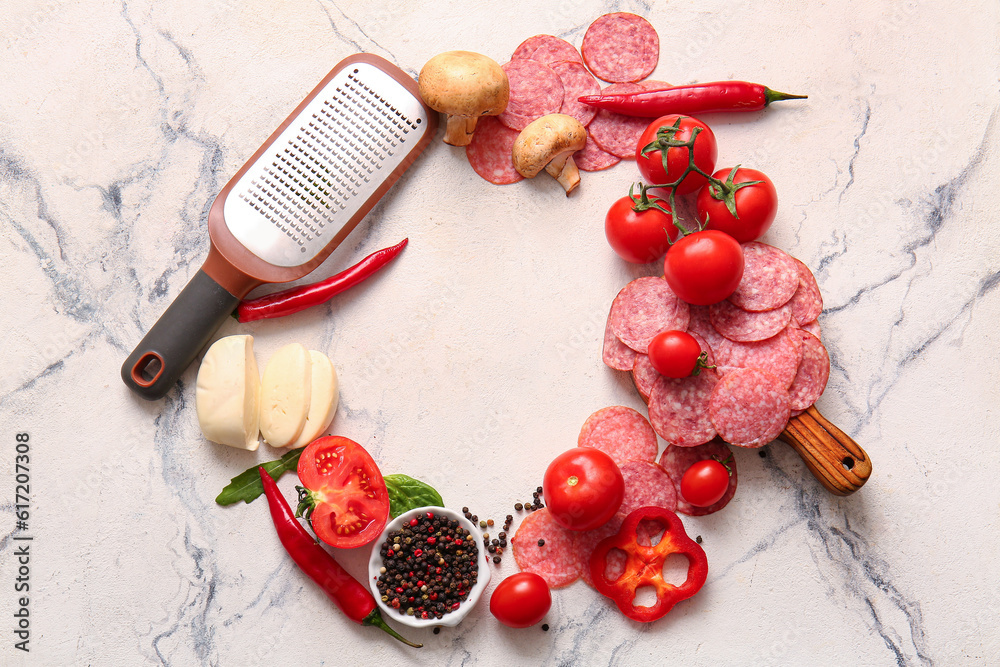 Frame made of ingredients for preparing pizza on white marble background