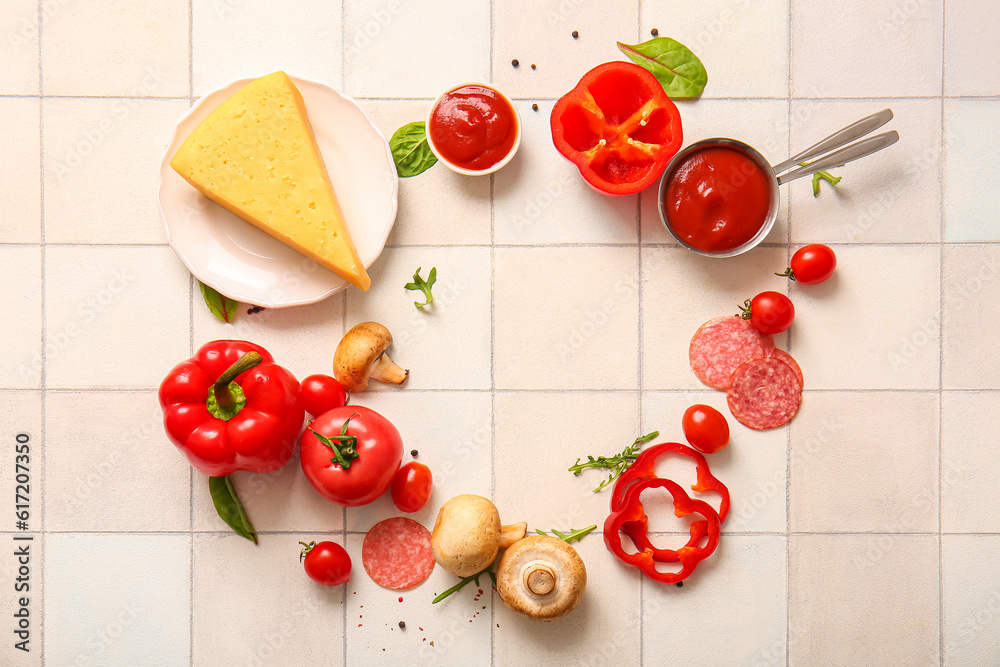 Frame made of ingredients for preparing pizza on white tile background