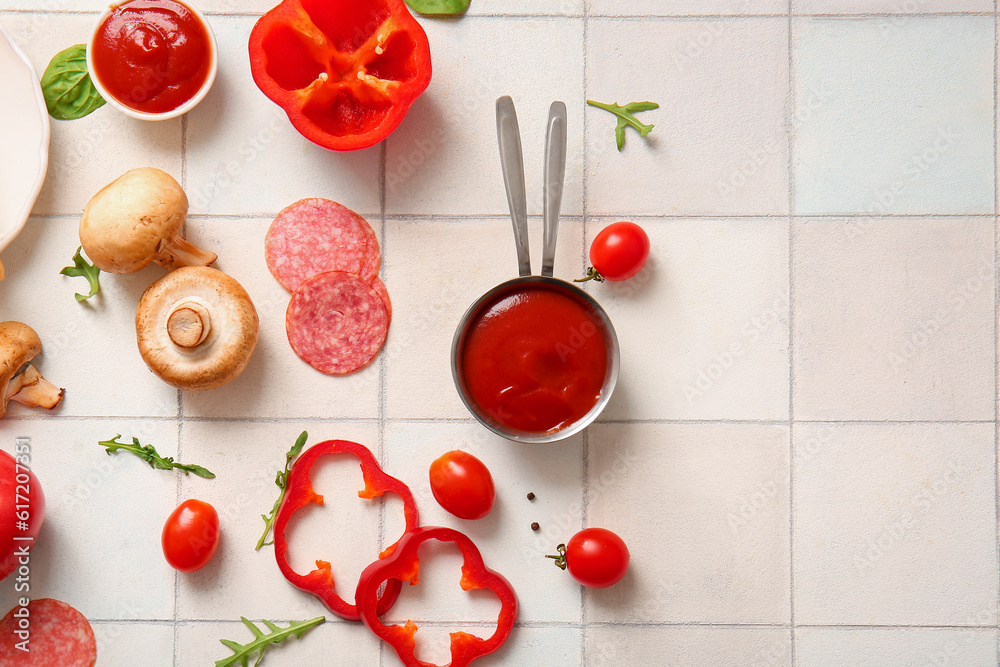 Different ingredients for preparing pizza on white tile background