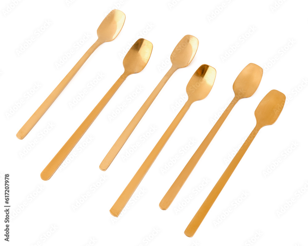 Golden spoons on white background