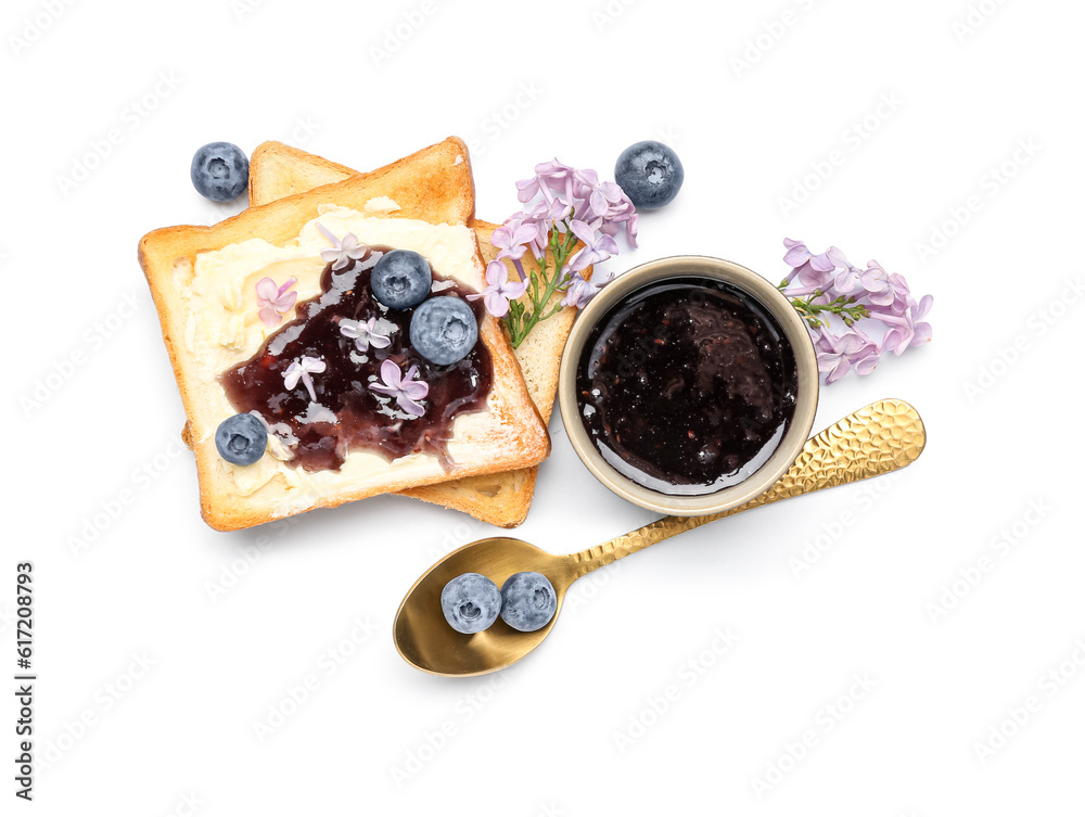 Bowl of sweet jam, delicious toasts, blueberries and lilac flowers isolated on white background