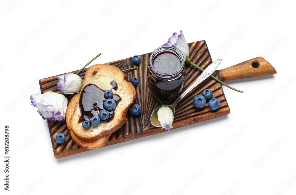 Wooden board with jar of blueberry jam, toasts and flowers isolated on white background