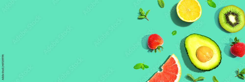 Avocado and mixed fruits overhead view flat lay