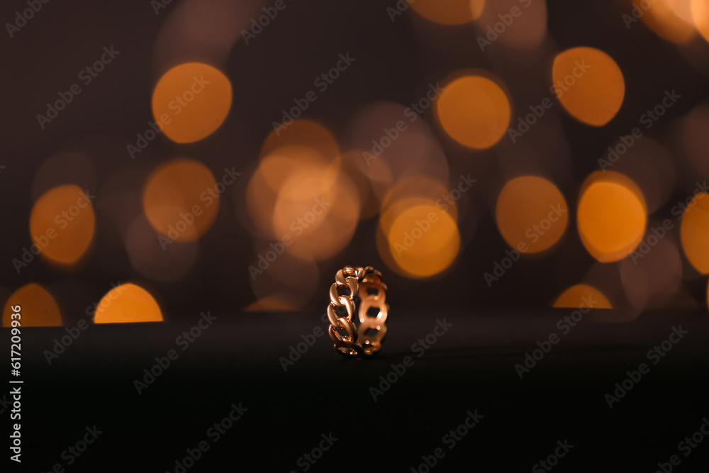 Beautiful ring on table against blurred lights