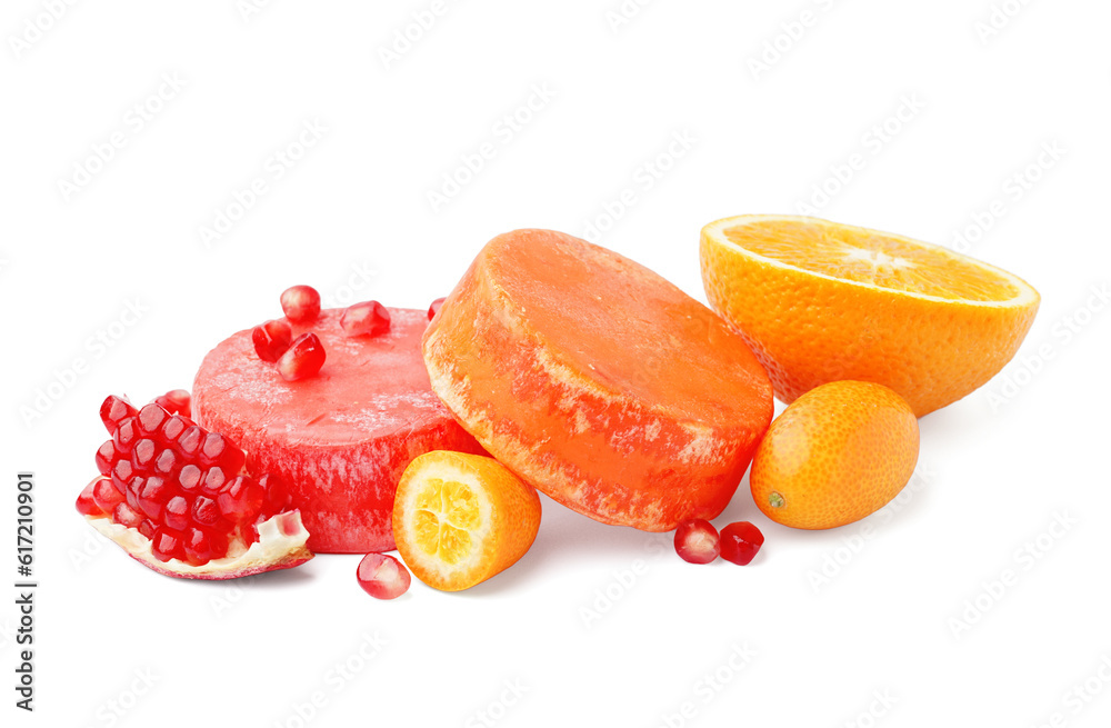 Colorful solid shampoo bars with orange, kumquat and pomegranate on white background