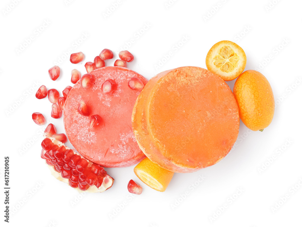 Colorful solid shampoo bars with orange, kumquat and pomegranate on white background