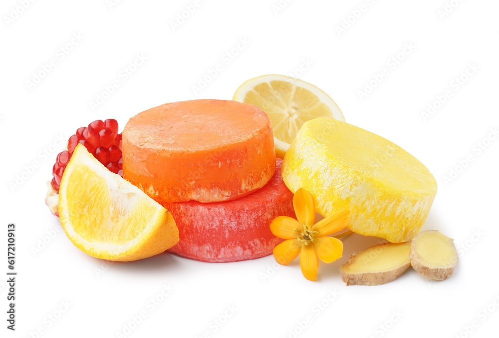 Colorful solid shampoo bars with lemon, ginger and pomegranate on white background