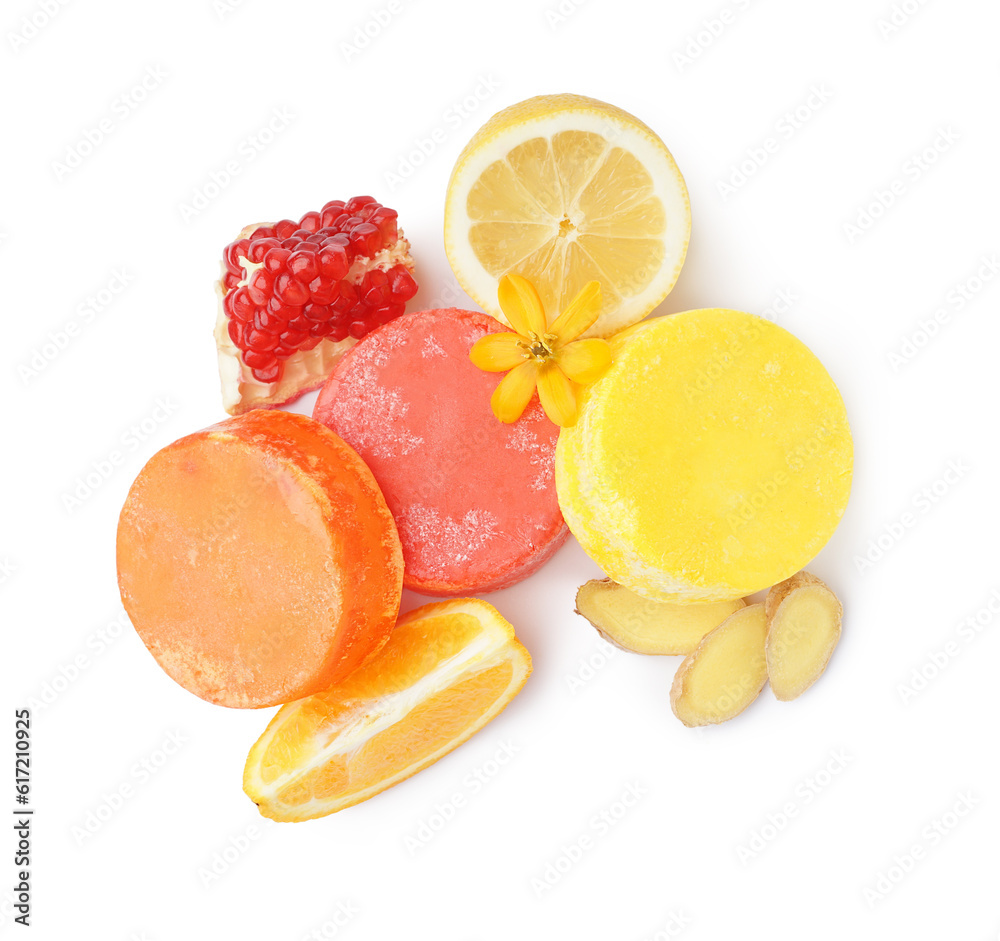 Colorful solid shampoo bars with lemon, ginger and pomegranate on white background