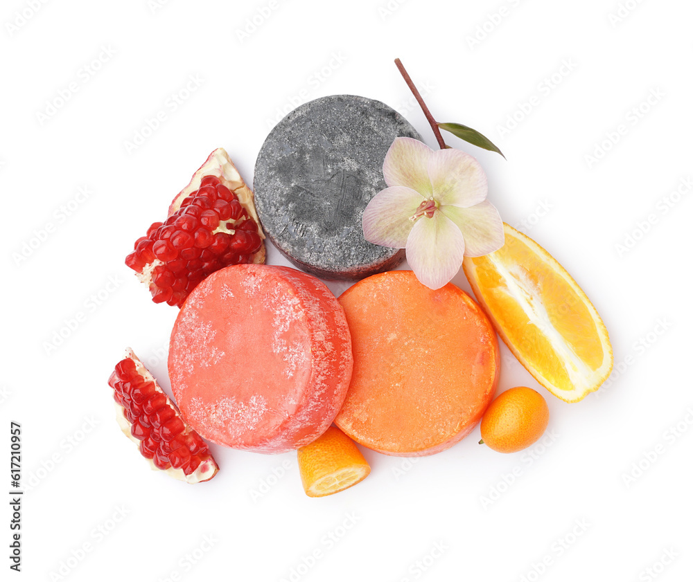 Colorful solid shampoo bars with flower, orange and pomegranate on white background