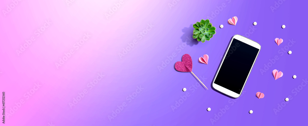 Smartphone with hearts and a succulent - flat lay