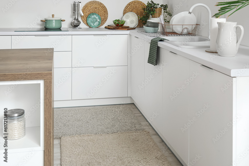 Soft rugs in interior of modern kitchen