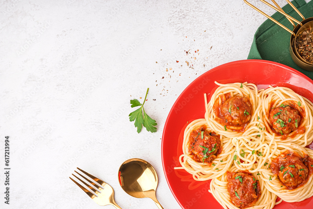 Plate of boiled pasta with tomato sauce and meat balls on white background