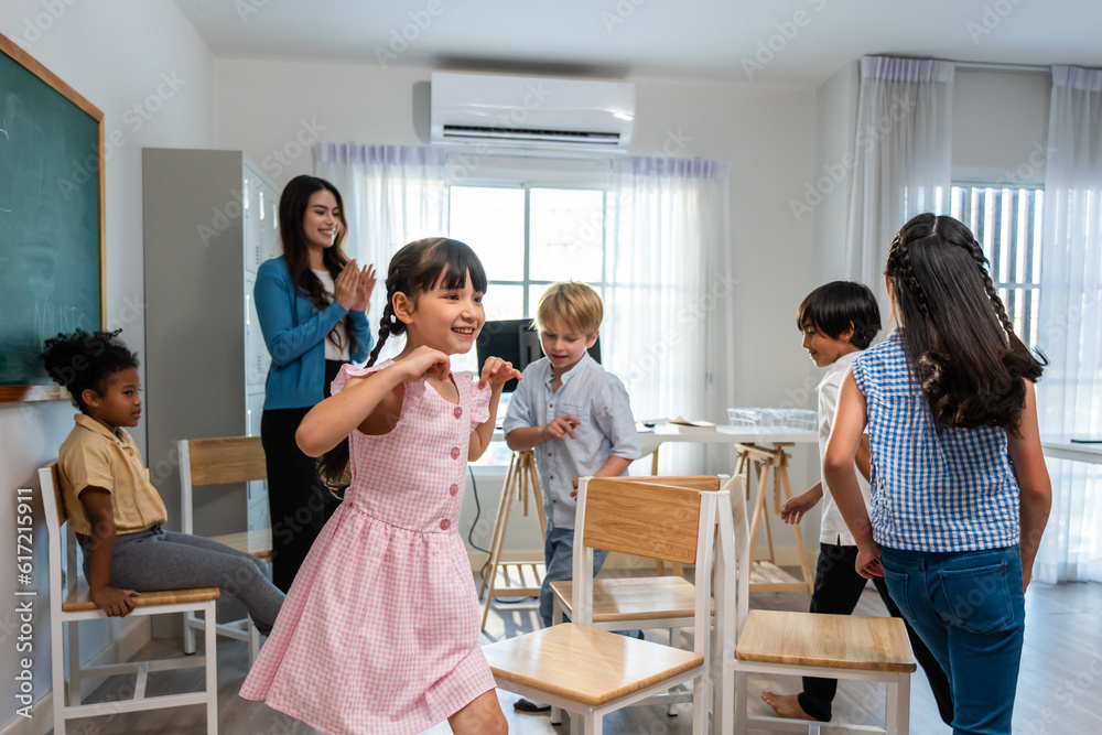 Group of student learn with teacher in classroom at elementary school. 